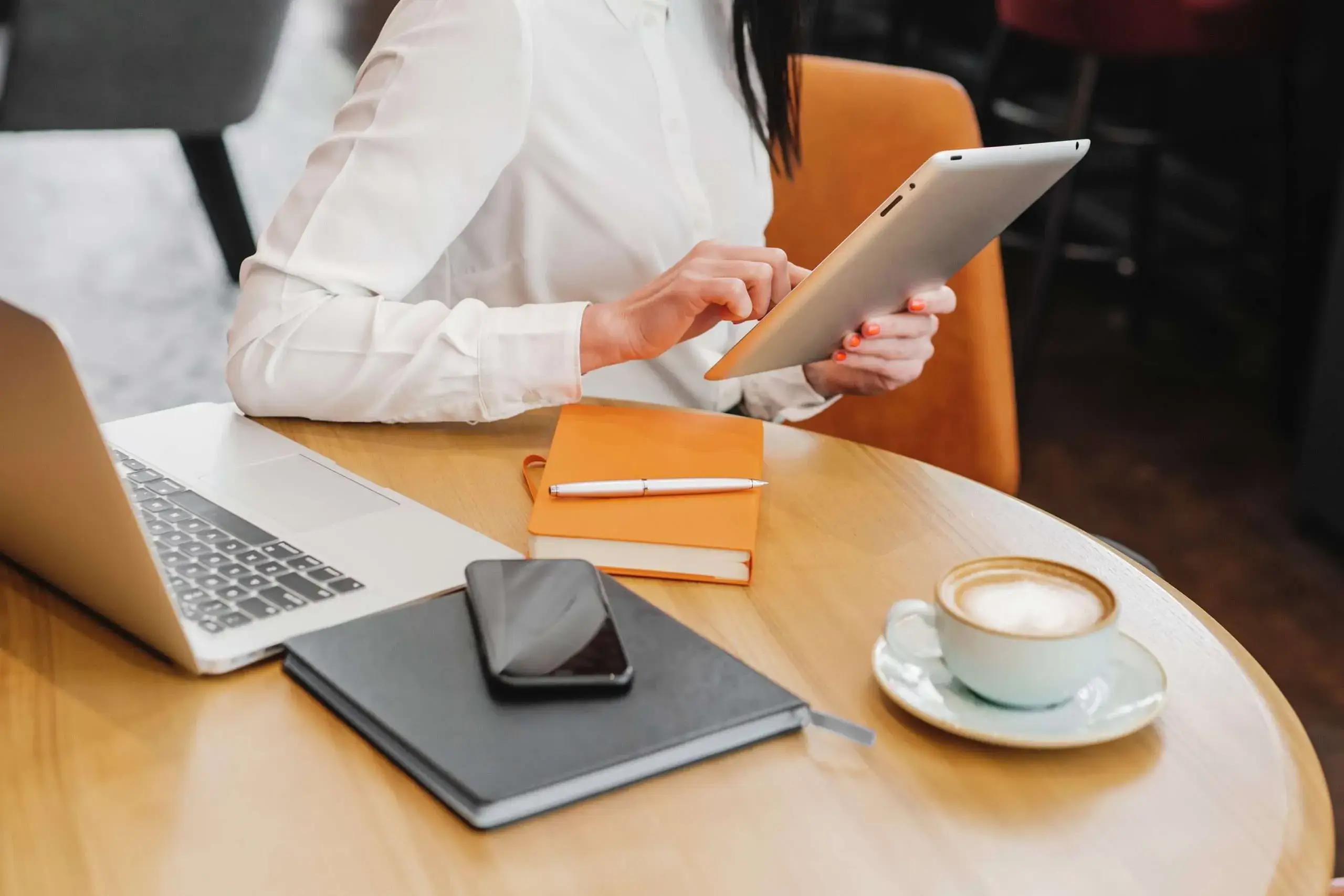 Girl working features with cup of coffee, notebook