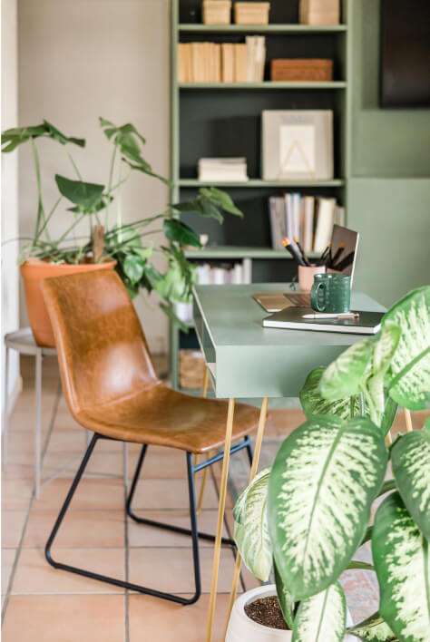 Home Office With A Brown Leather Chair, A Green Desk With A Laptop
