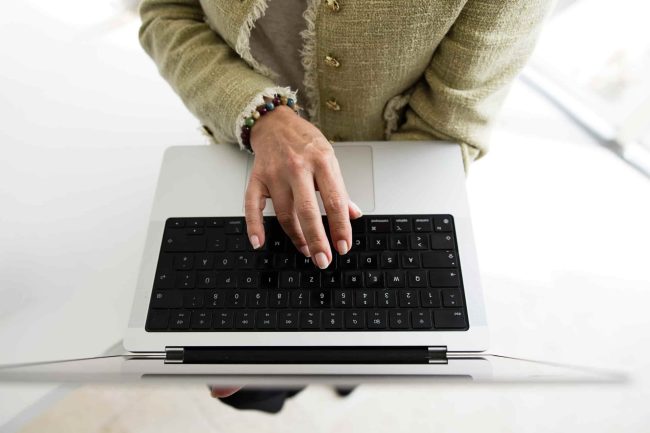 Business professional using a laptop on a desk